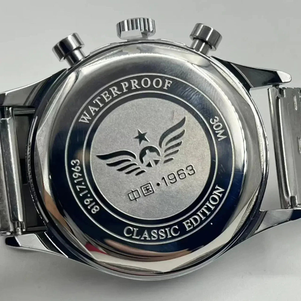 Close-up of a silver watch with 'Waterproof' and 'Classic Edition' text on a gray background