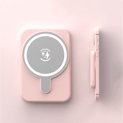 Pink handheld mirror with a light on a pink background