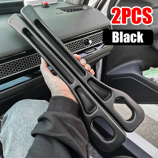 Two black car door guards held by a person inside a vehicle.