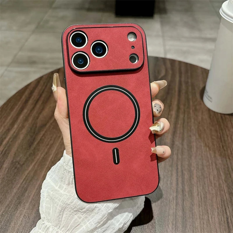 Red phone case with a unique design held by a hand on a wooden surface.