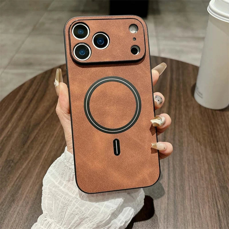 Brown phone case with a circular design held by a hand on a wooden surface.