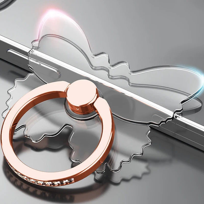 Rose gold ring holder on a reflective surface with a blurred background